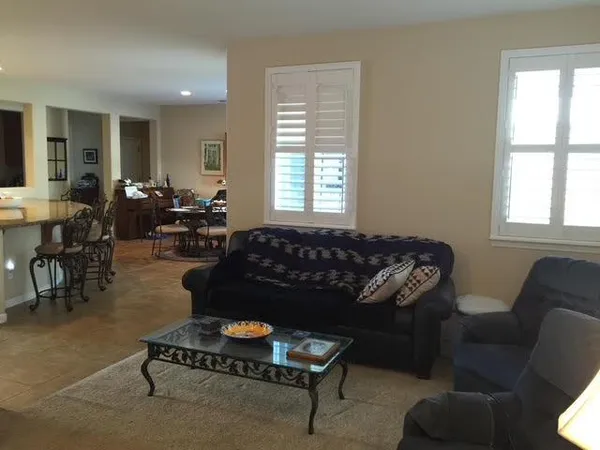 a living room with furniture fireplace and window
