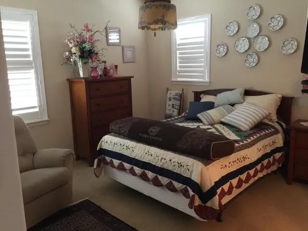 a bedroom with a bed window and couch