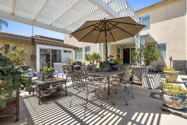 a view of a patio with table and chairs under an umbrella