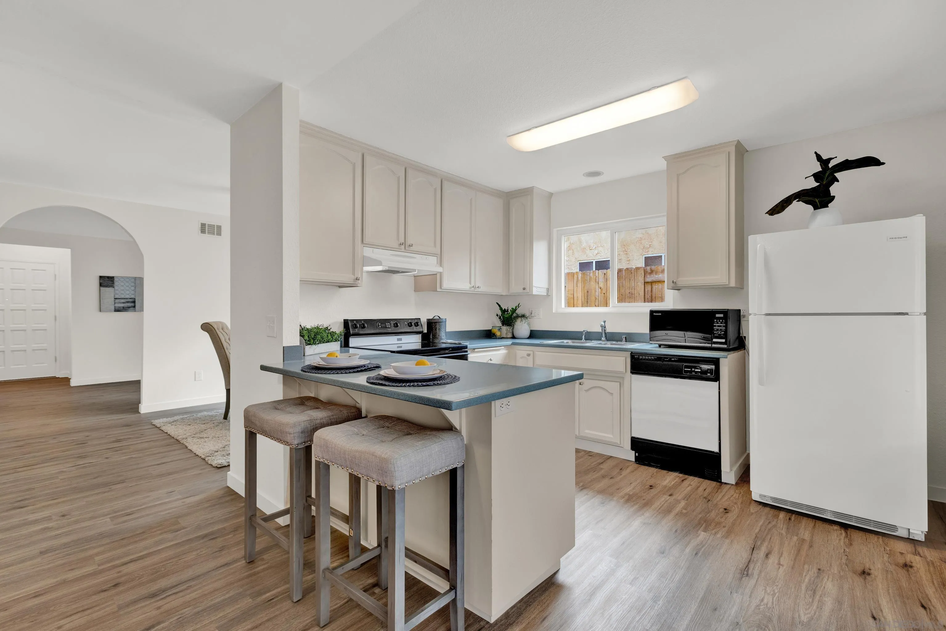 14056 Mazatlan Way Poway, CA 92064 - Photo 8 of 23 a kitchen with stainless steel appliances granite countertop a refrigerator a stove a sink dishwasher and a refrigerator with wooden floor