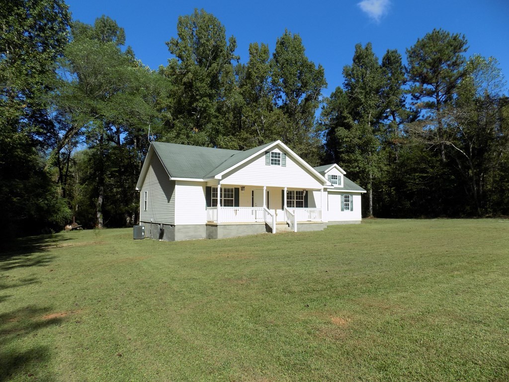 166 Patton Road Gray, GA 31032 - Photo 2 of 22 a white house with a small yard and large trees
