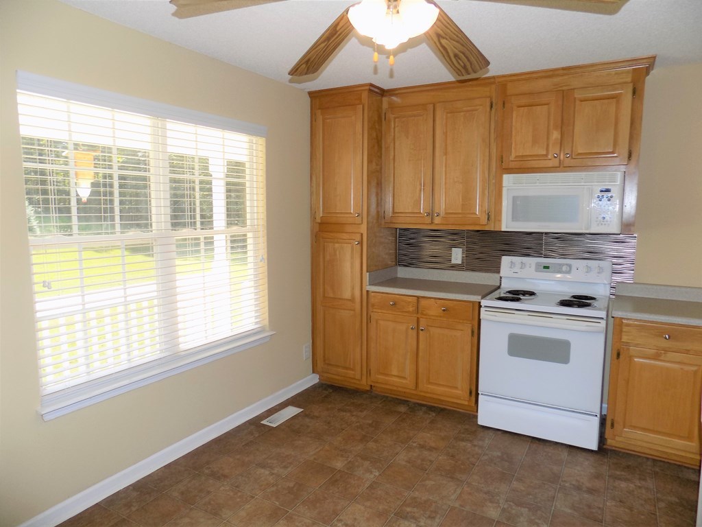 166 Patton Road Gray, GA 31032 - Photo 12 of 22 a kitchen with a stove a sink and a window