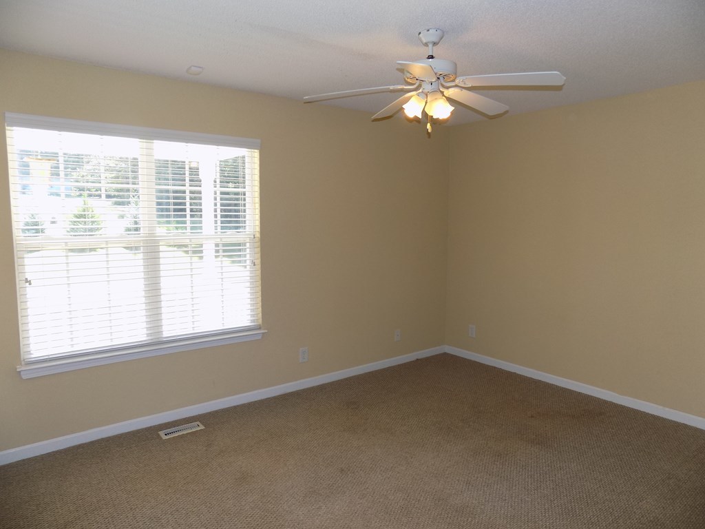166 Patton Road Gray, GA 31032 - Photo 14 of 22 an empty room with a window and a ceiling fan