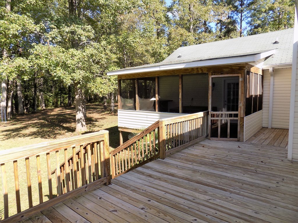 166 Patton Road Gray, GA 31032 - Photo 16 of 22 swimming view of a house with wooden deck and floor to ceiling windows