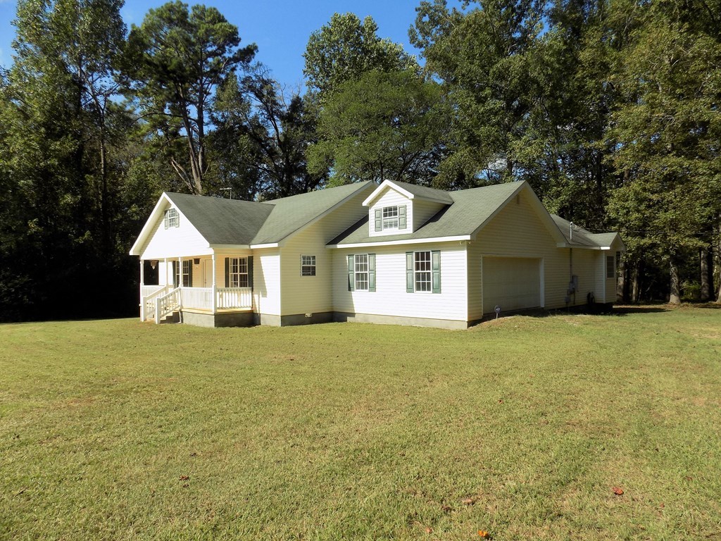 166 Patton Road Gray, GA 31032 - Photo 19 of 22 a front view of a house with a garden and tree