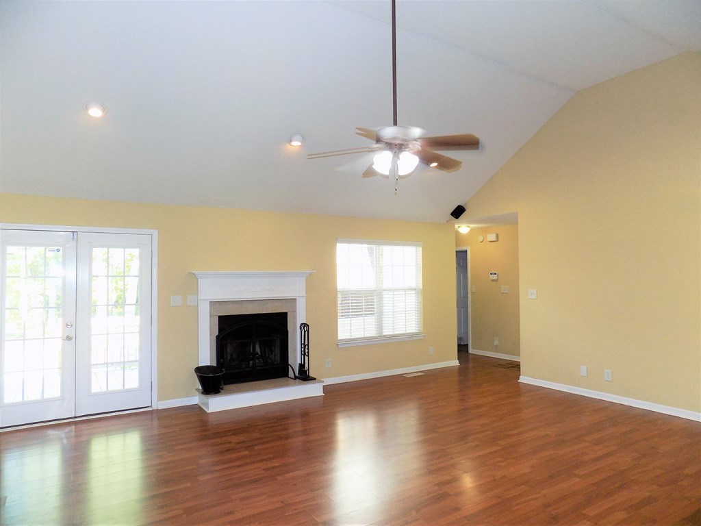 166 Patton Road Gray, GA 31032 - Photo 3 of 22 a view of an empty room with wooden floor fireplace and a window