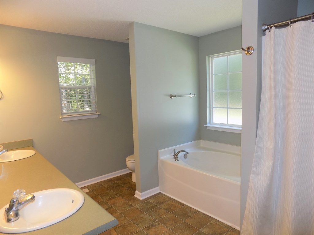 166 Patton Road Gray, GA 31032 - Photo 8 of 22 a white bath tub sitting next to a white toilet