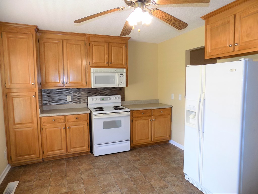 166 Patton Road Gray, GA 31032 - Photo 10 of 22 a kitchen with white cabinets and white appliances
