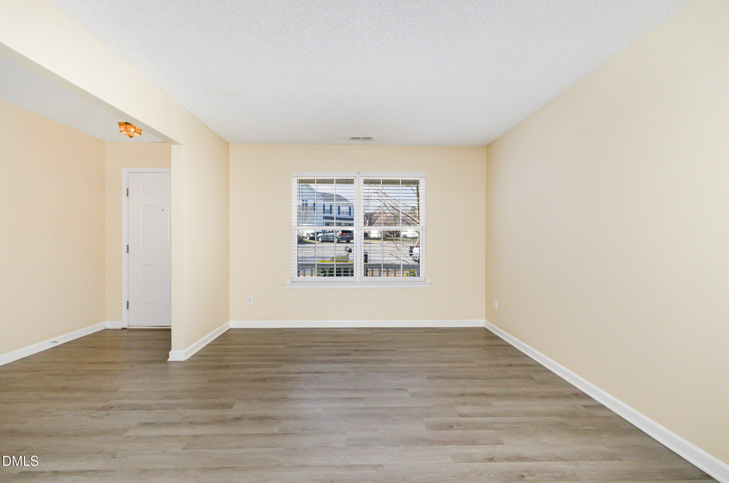 4809 Kaycee Court Raleigh, NC 27616 - Photo 11 of 41 a view of an empty room with wooden floor and a window