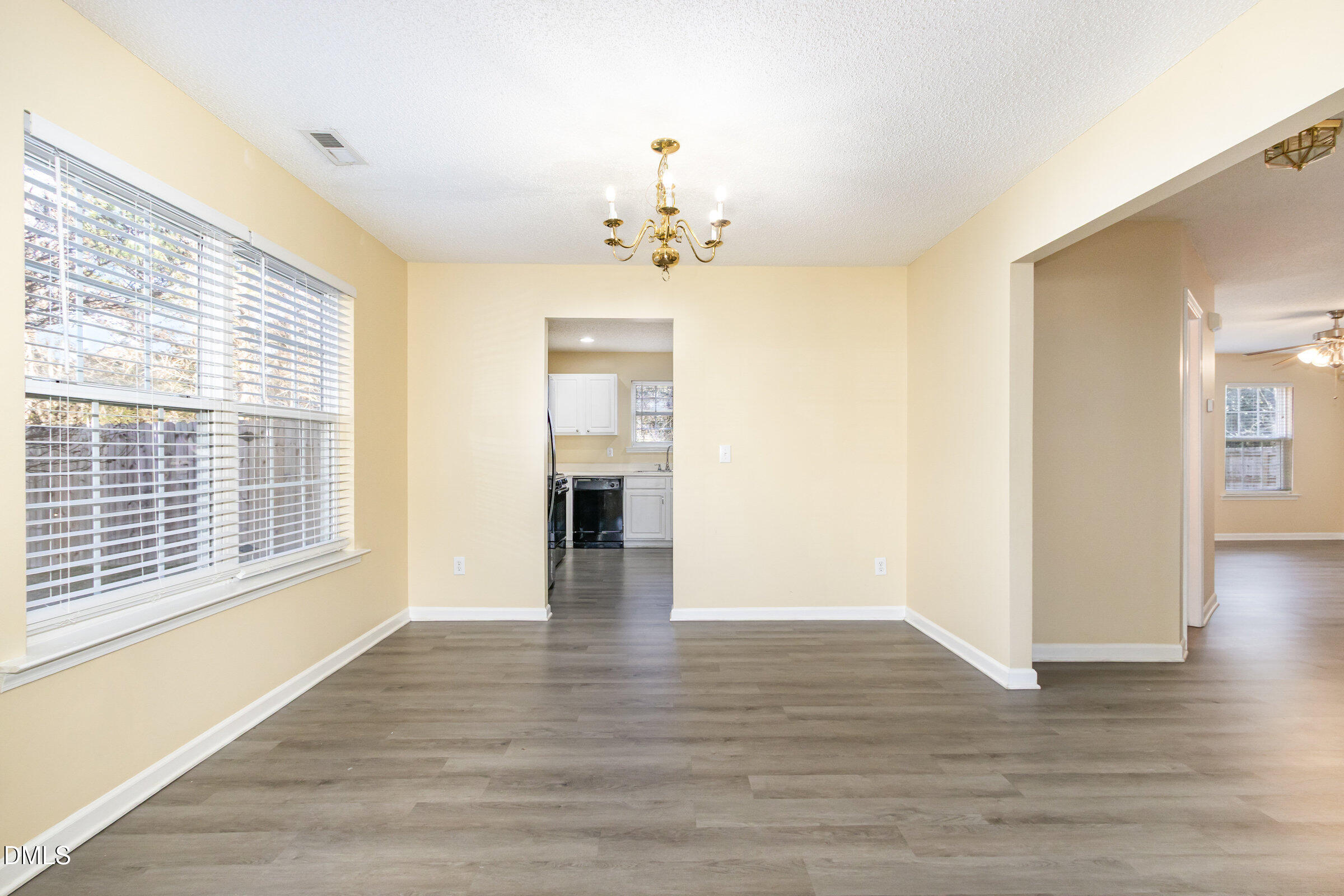 4809 Kaycee Court Raleigh, NC 27616 - Photo 14 of 41 a view of an empty room with window and wooden floor