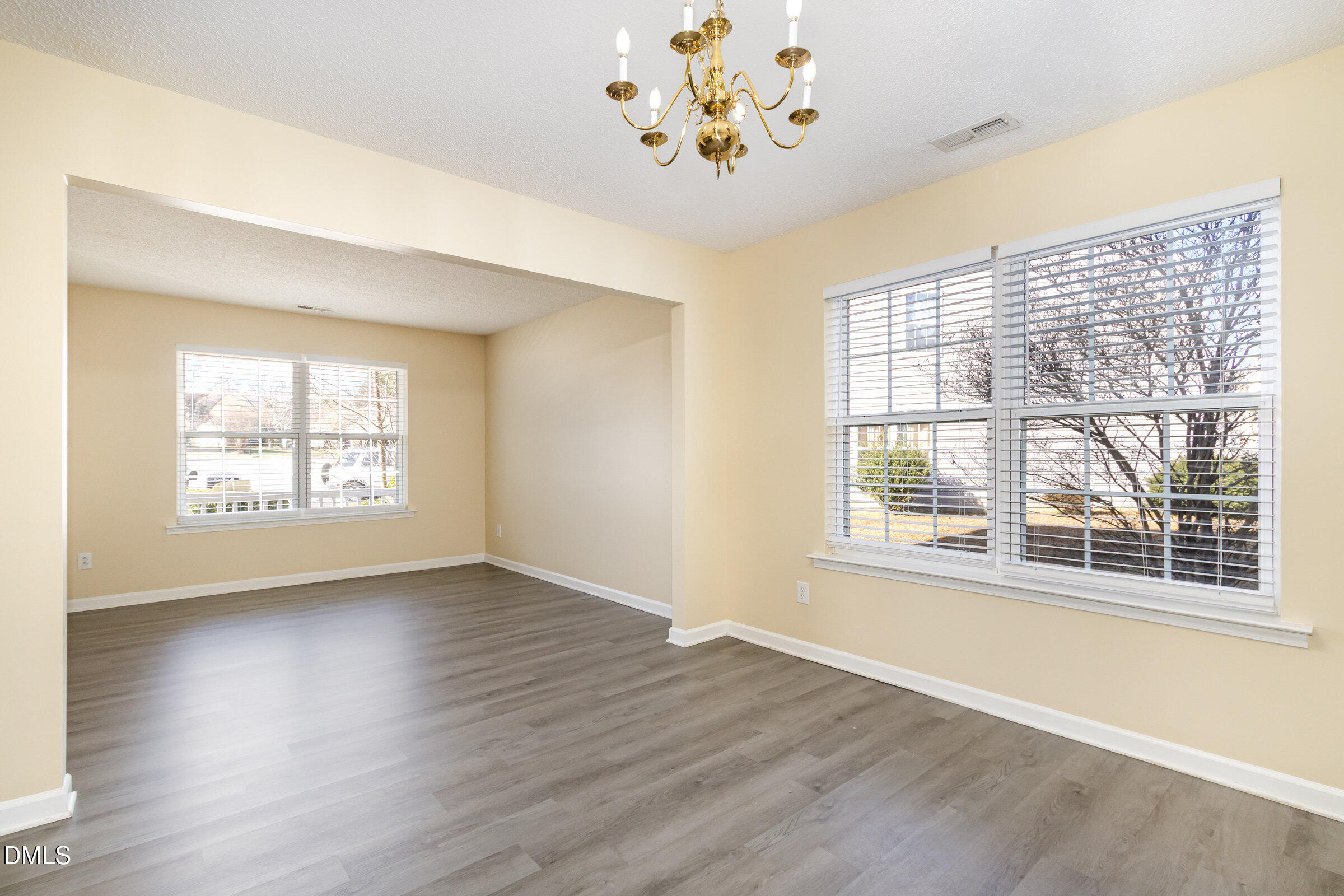 4809 Kaycee Court Raleigh, NC 27616 - Photo 16 of 41 an empty room with wooden floor and windows