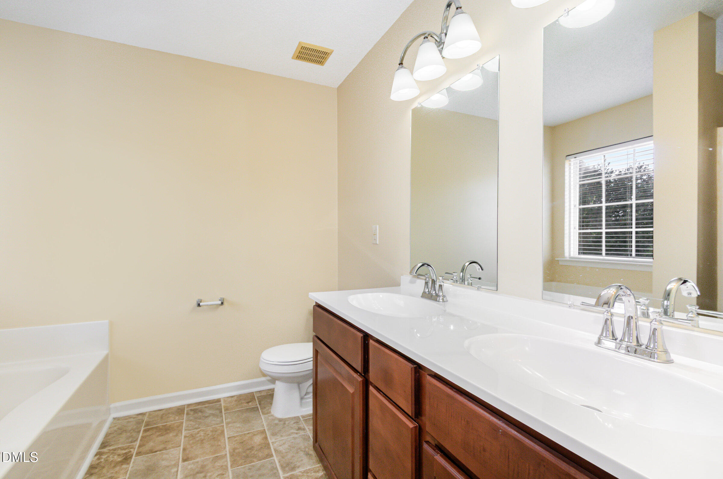4809 Kaycee Court Raleigh, NC 27616 - Photo 34 of 41 a bathroom with a sink a toilet and a mirror