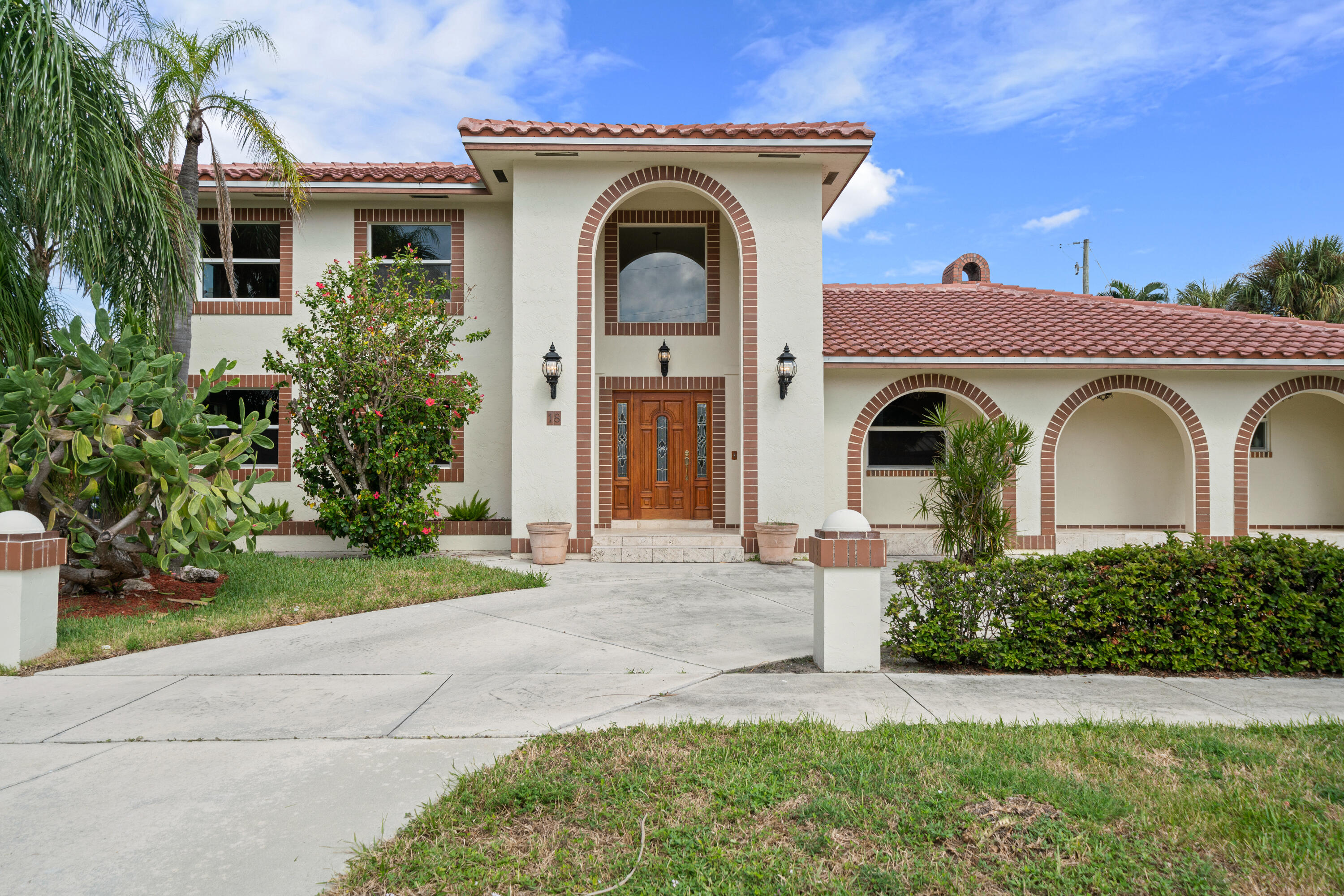 18 Duke Drive Lake Worth, FL 33460 - Photo 2 of 29 a front view of a house with garden