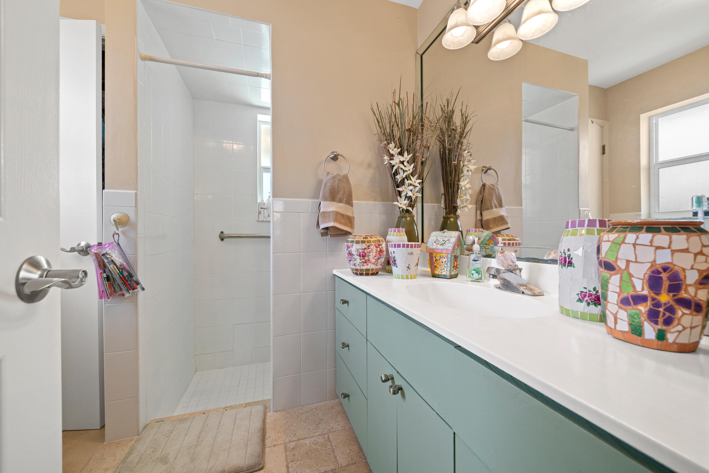 18 Duke Drive Lake Worth, FL 33460 - Photo 16 of 29 a bathroom with a sink a mirror and shower