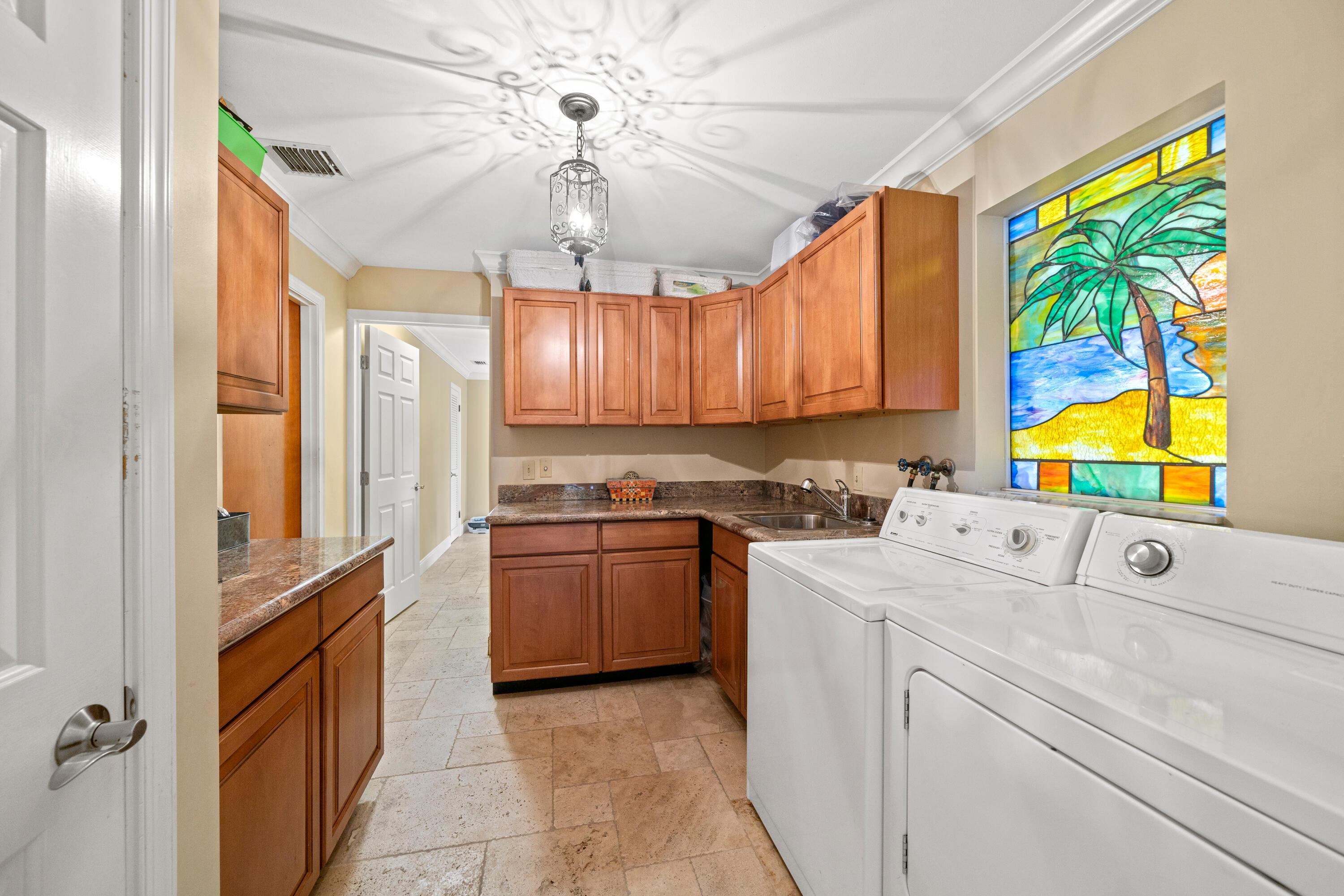 18 Duke Drive Lake Worth, FL 33460 - Photo 18 of 29 a kitchen with stainless steel appliances granite countertop a stove a sink and a refrigerator