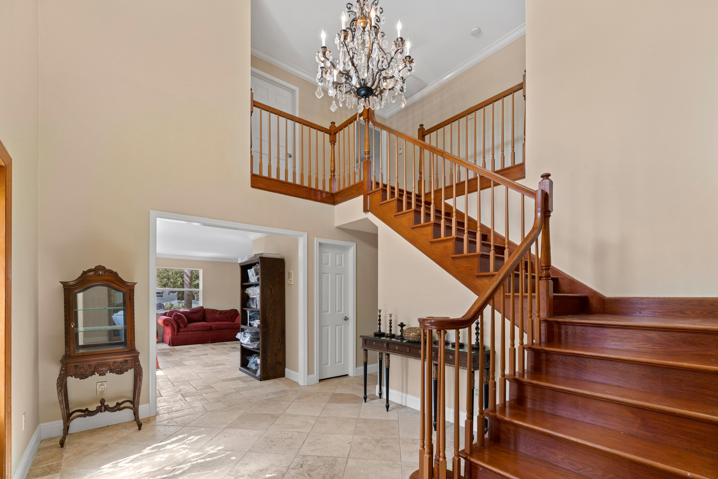 18 Duke Drive Lake Worth, FL 33460 - Photo 20 of 29 a view of staircase with furniture and a chandelier