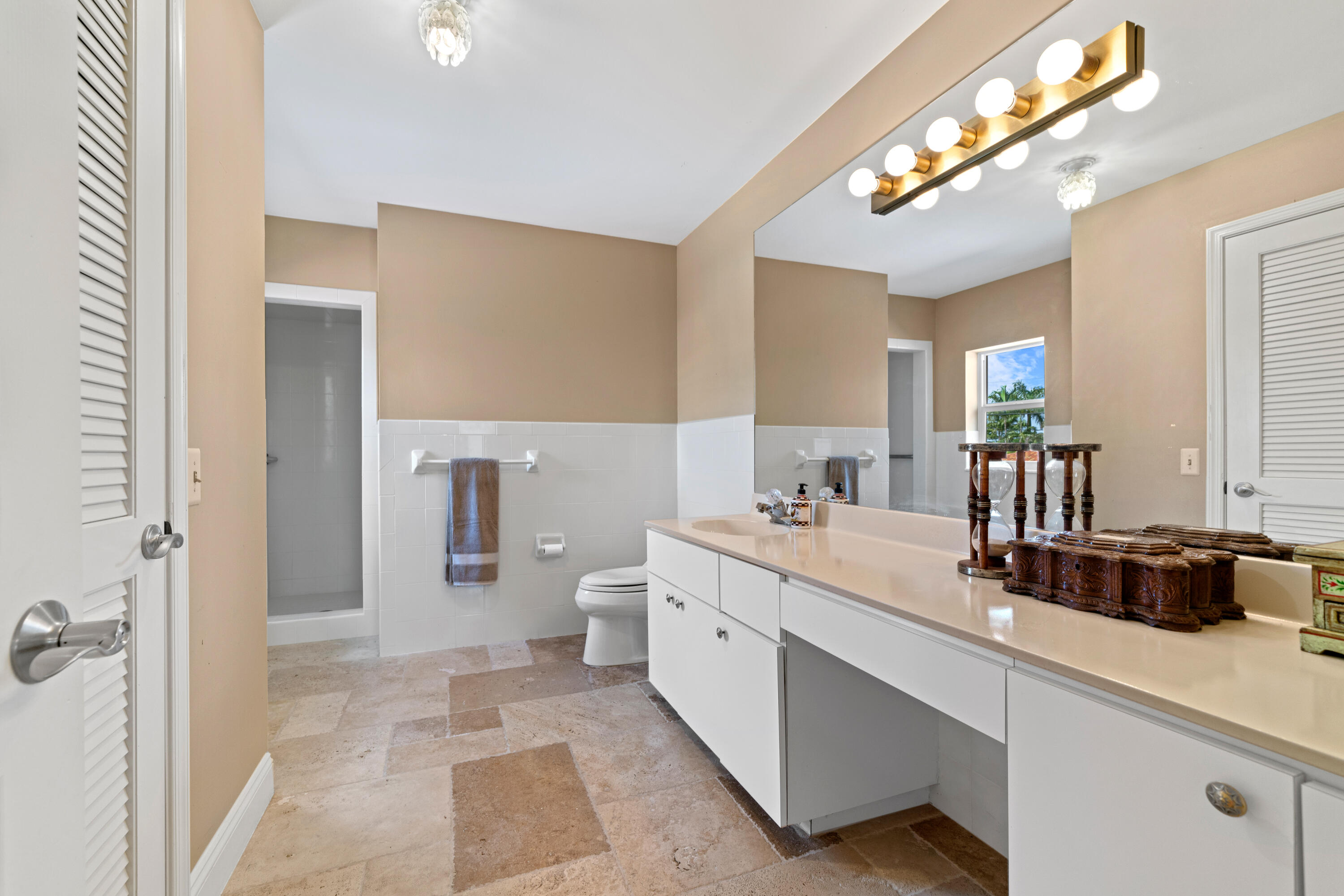 18 Duke Drive Lake Worth, FL 33460 - Photo 22 of 29 a bathroom with a double vanity sink a mirror and a shower