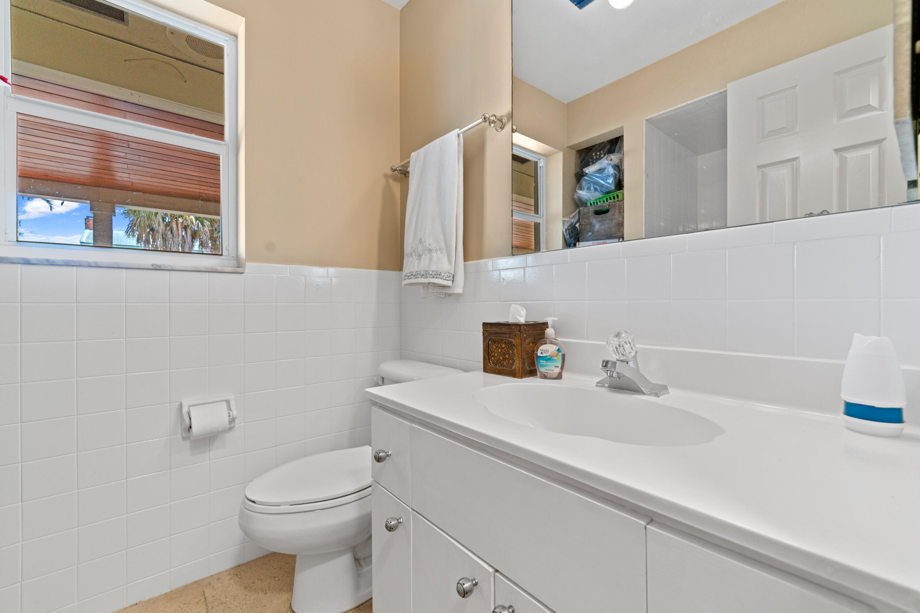 18 Duke Drive Lake Worth, FL 33460 - Photo 24 of 29 a bathroom with a sink a toilet and a mirror