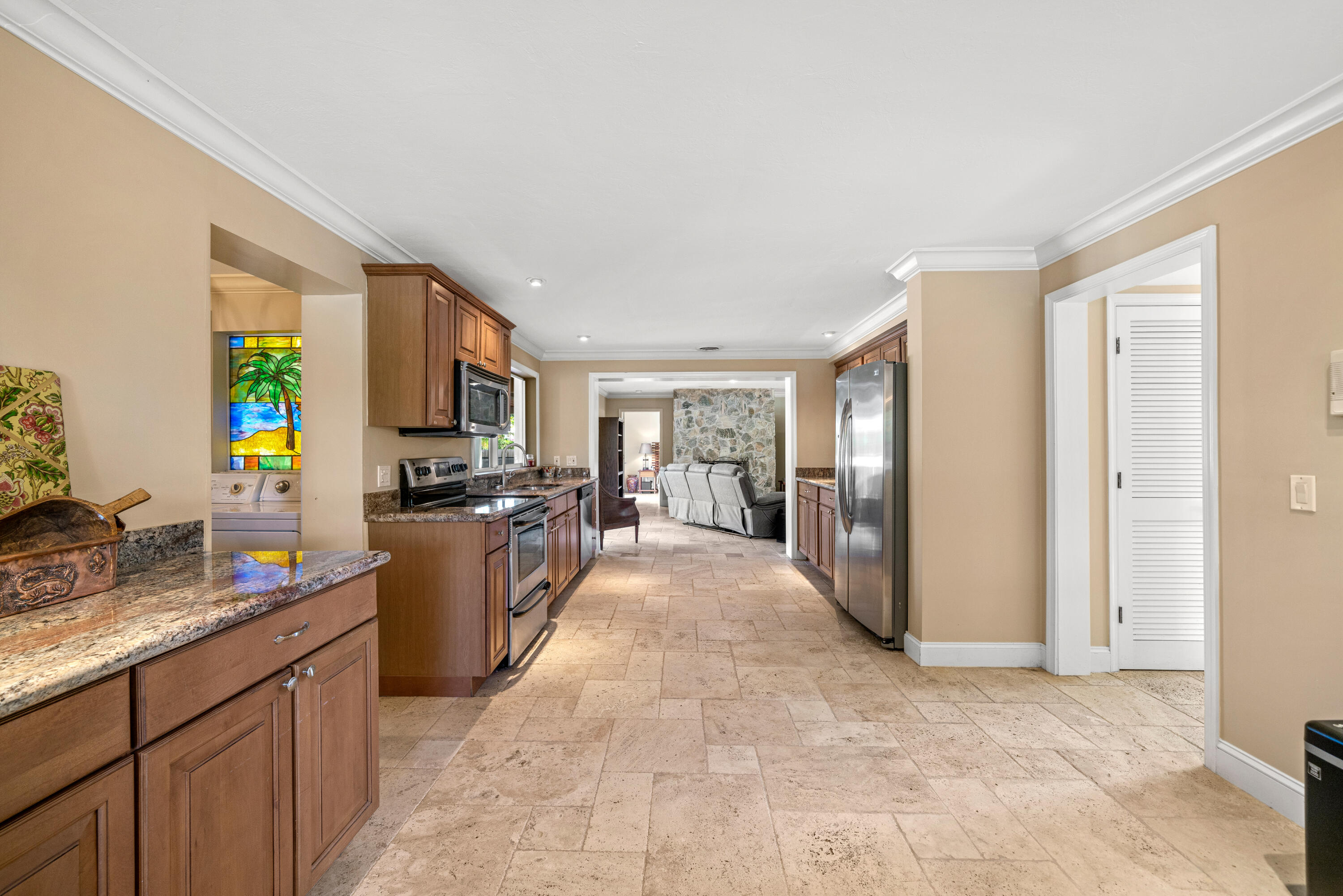 18 Duke Drive Lake Worth, FL 33460 - Photo 8 of 29 a large kitchen with a large counter top appliances and cabinets