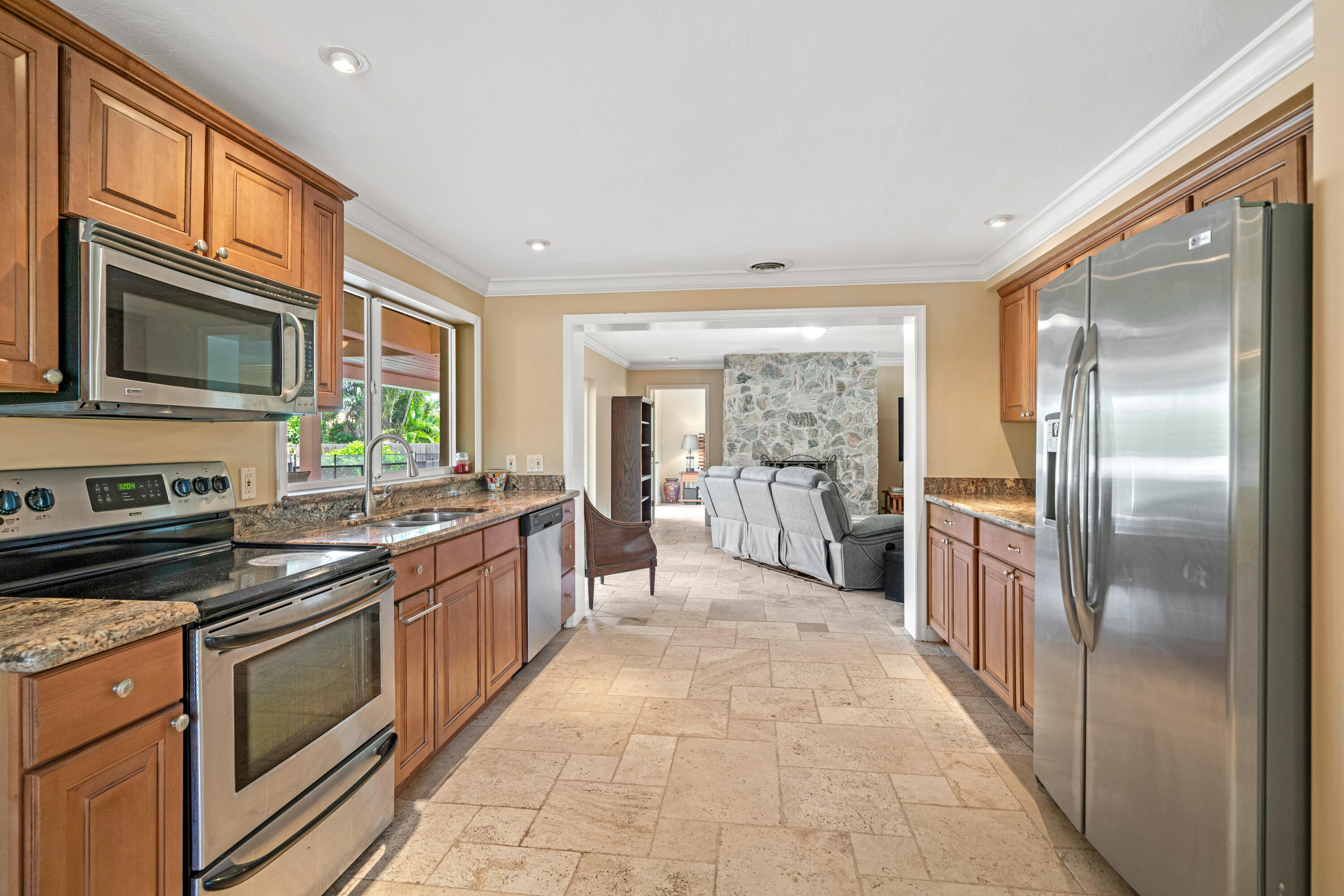 18 Duke Drive Lake Worth, FL 33460 - Photo 9 of 29 a large kitchen with stainless steel appliances granite countertop a refrigerator and a stove top oven
