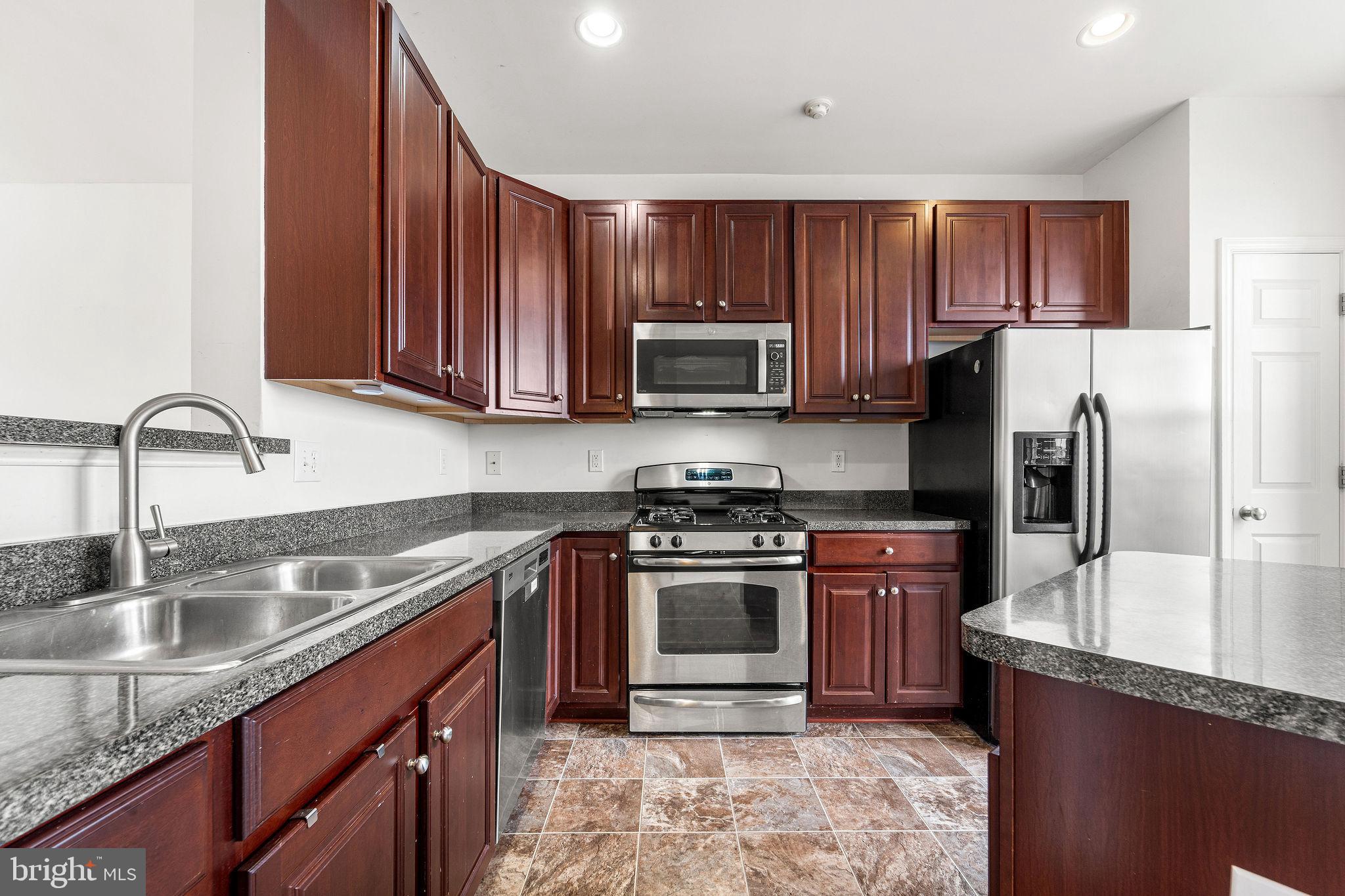 22 River Lane Delanco, NJ 08075 - Photo 14 of 43 a kitchen with stainless steel appliances granite countertop a sink stove and refrigerator