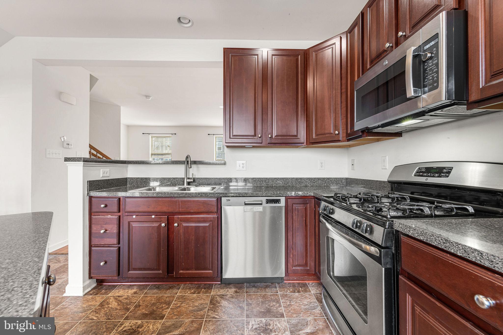22 River Lane Delanco, NJ 08075 - Photo 16 of 43 a kitchen with stainless steel appliances granite countertop a stove and a microwave