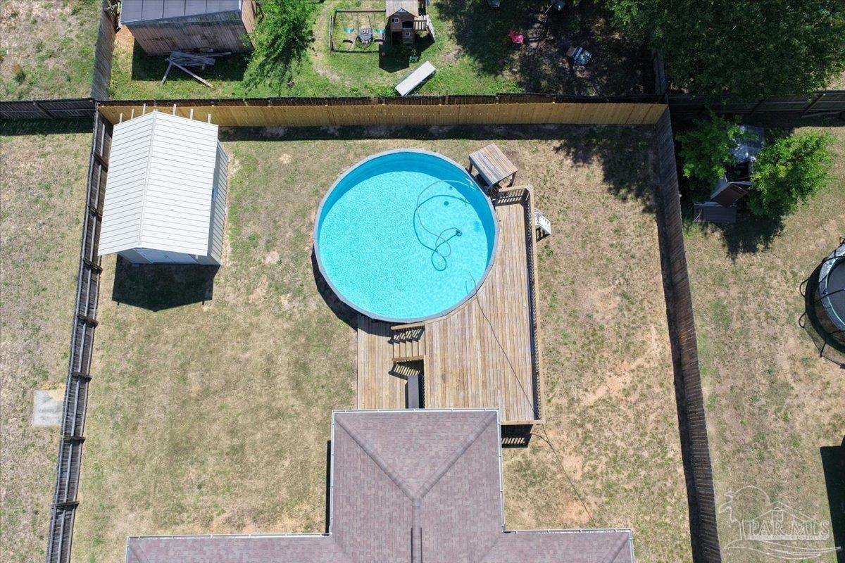 4015 Berry Circle Pace, FL 32571 - Photo 48 of 48 swimming pool view with a garden and plants