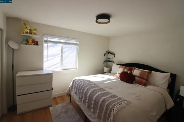 a bedroom with a bed and chair