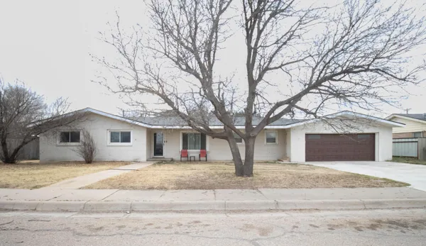 a house that has a tree in front of it