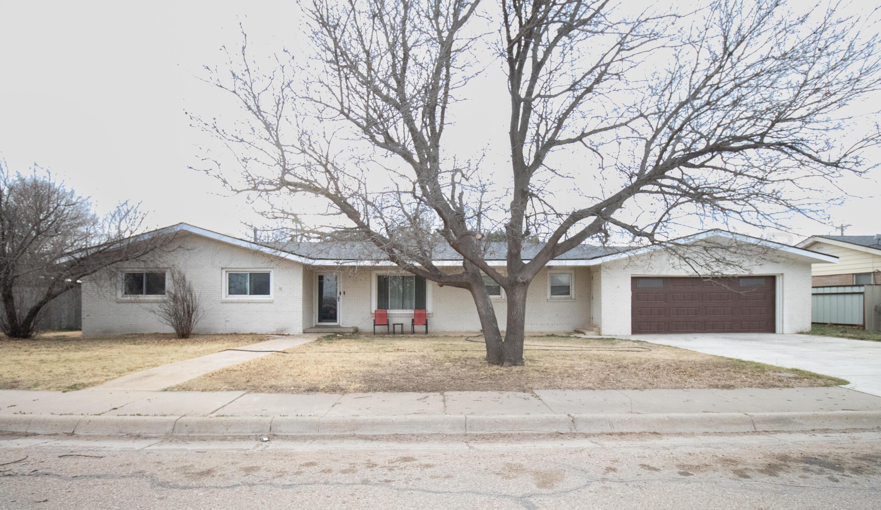 1205 Division Street Stratford, TX 79084 - Photo 1 of 14 a house that has a tree in front of it