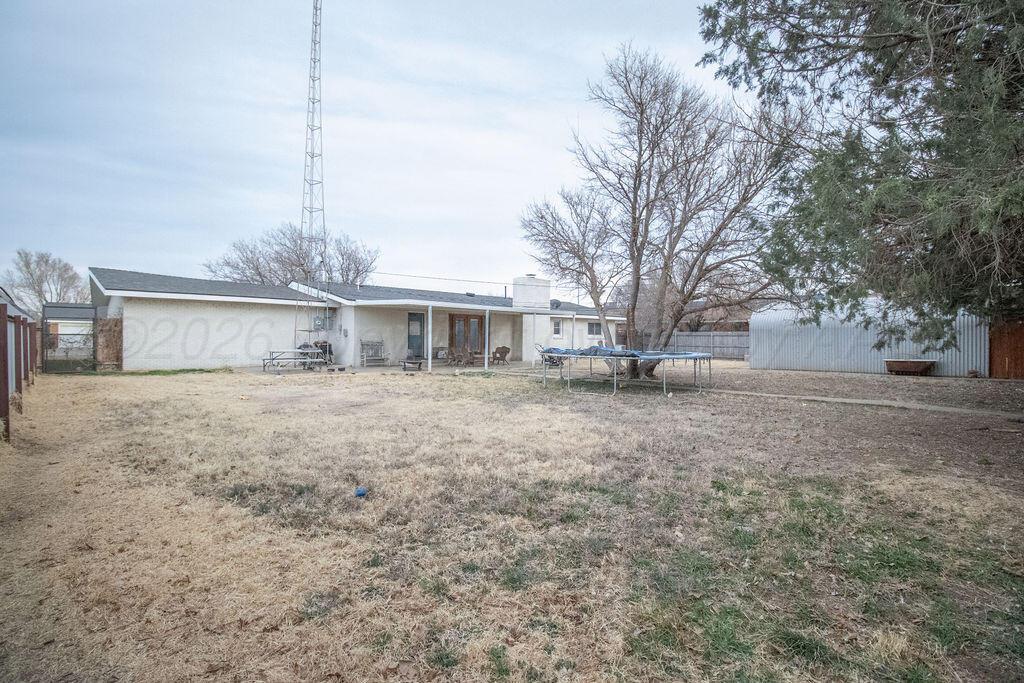 1205 Division Street Stratford, TX 79084 - Photo 14 of 14 a front view of residential houses with yard and trees