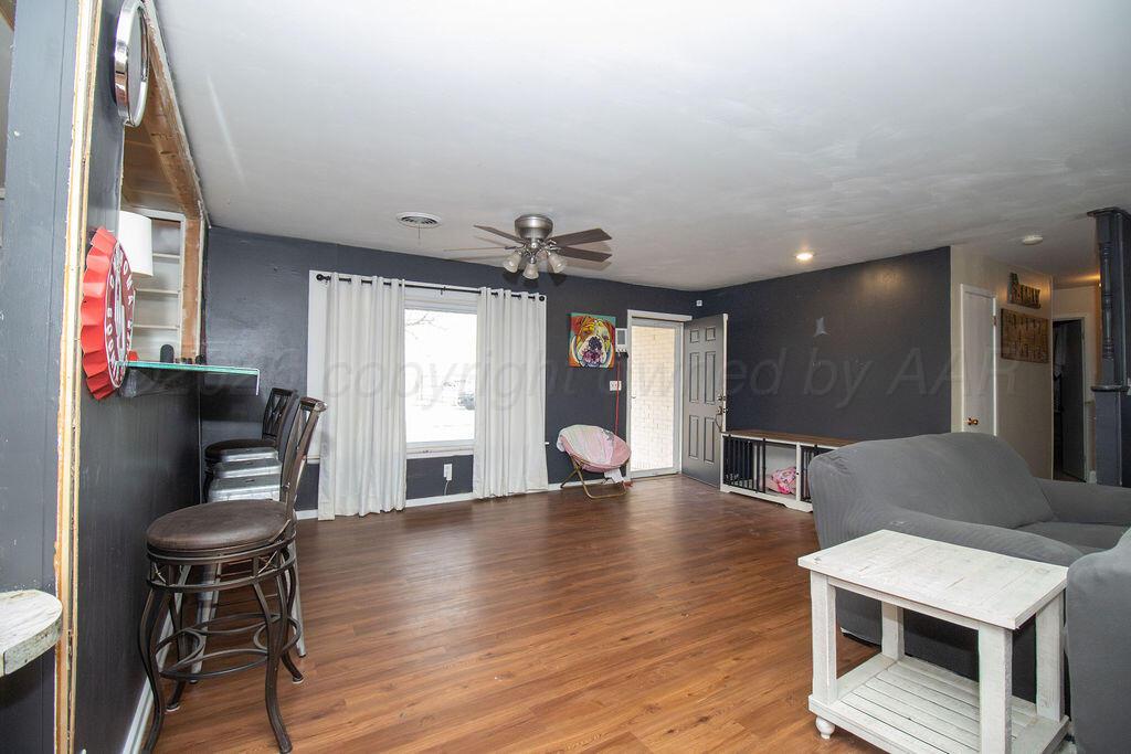 1205 Division Street Stratford, TX 79084 - Photo 2 of 14 a view of kitchen with furniture and wooden floor