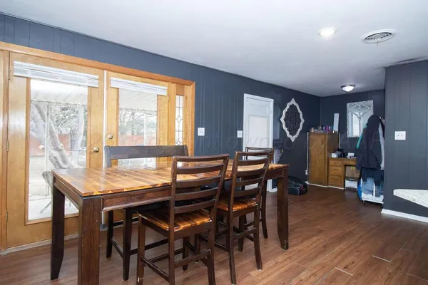 a view of a dining room with furniture and wooden floor