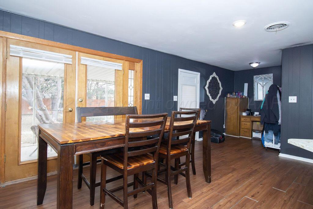 1205 Division Street Stratford, TX 79084 - Photo 4 of 14 a view of a dining room with furniture and wooden floor