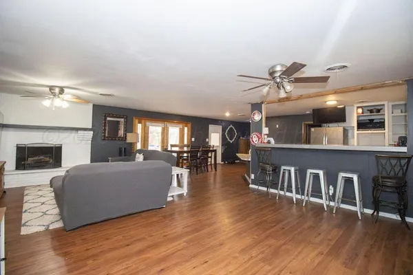 a living room with furniture and a wooden floor