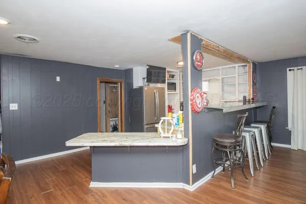 a view of kitchen with cabinets and wooden floor