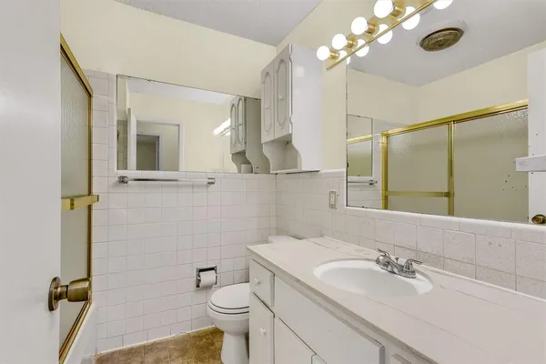 a bathroom with a sink a toilet and mirror