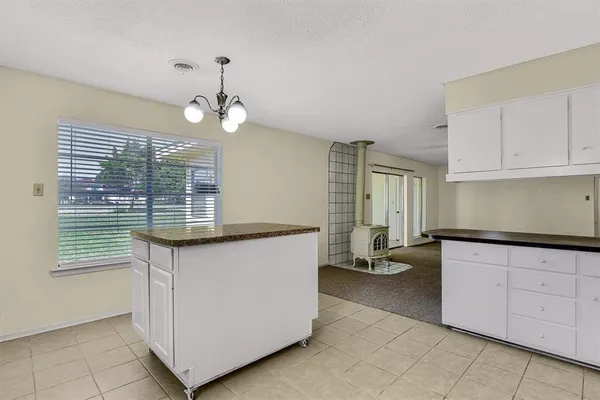 a kitchen with granite countertop a sink and a stove