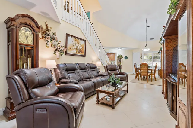 a living room with furniture a couch and a chandelier
