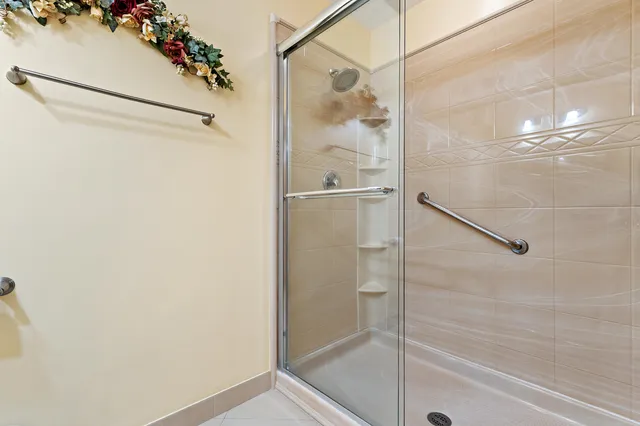 a bathroom with a glass shower door
