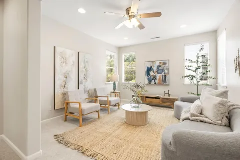 a living room with furniture and a large window