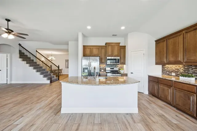 a view of kitchen with sink and wooden floor
