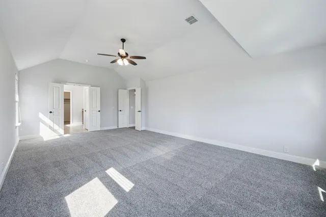 an empty room with fan and windows
