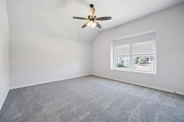 an empty room with fan and windows