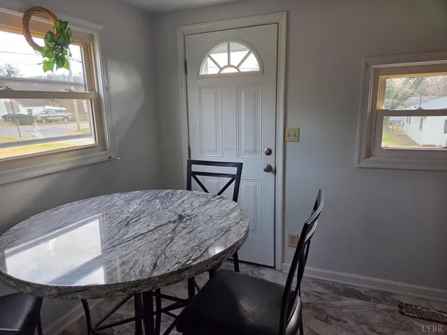 a view of a dining room with furniture and window