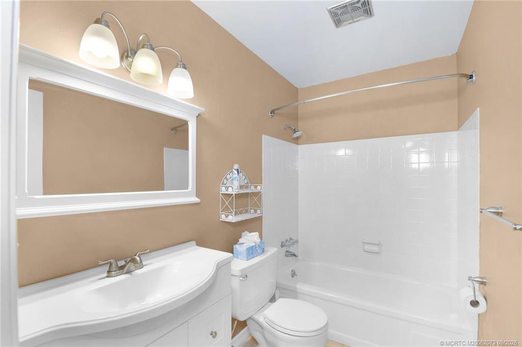 2929 Southeast Ocean Boulevard, Unit 1294 Stuart, FL 34996 - Photo 15 of 30 a bathroom with a bathtub shower sink vanity and toilet