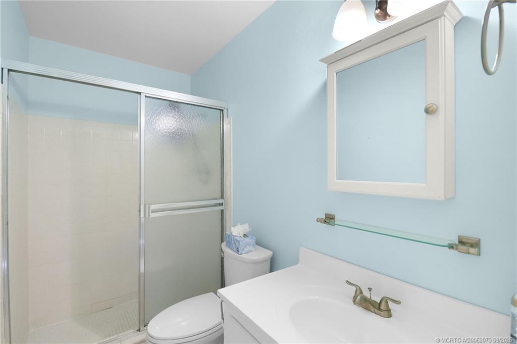 2929 Southeast Ocean Boulevard, Unit 1294 Stuart, FL 34996 - Photo 17 of 30 a bathroom with a sink a toilet and shower