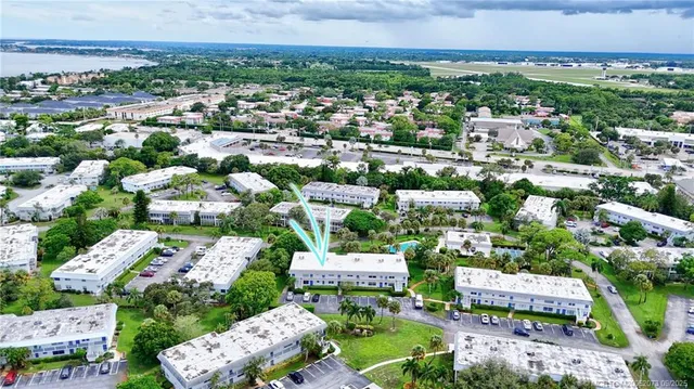 an outdoor space with seating area and trees in the background