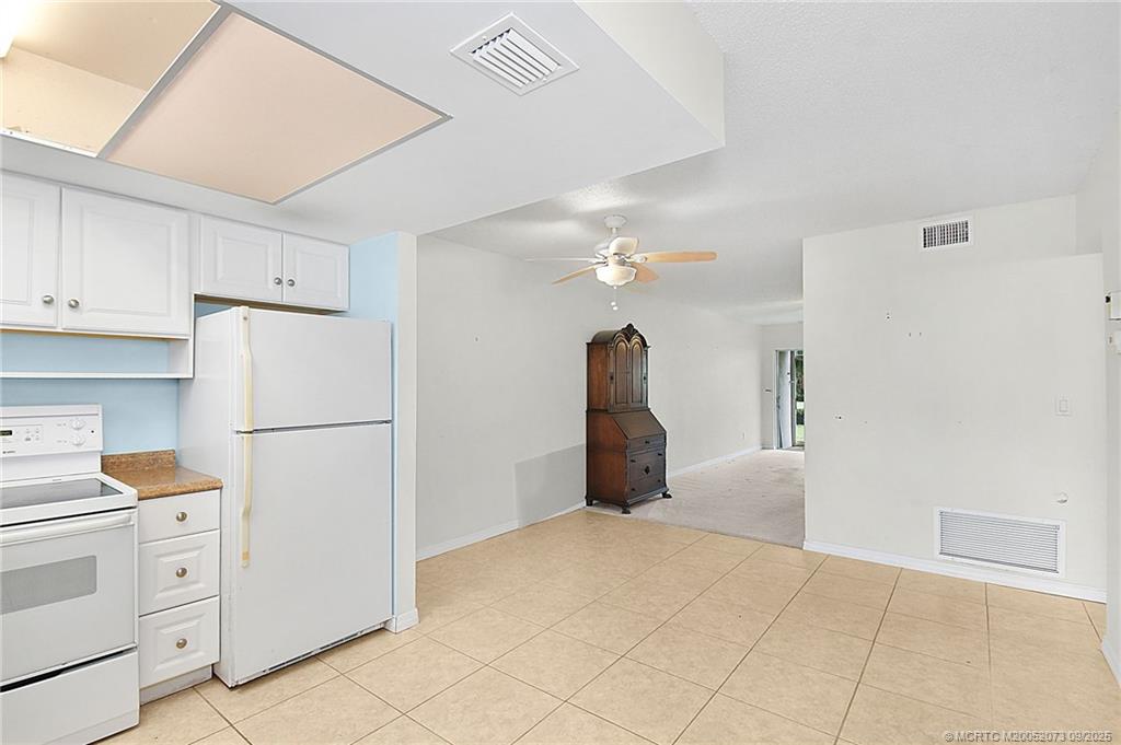 2929 Southeast Ocean Boulevard, Unit 1294 Stuart, FL 34996 - Photo 3 of 30 a kitchen with cabinets and appliances