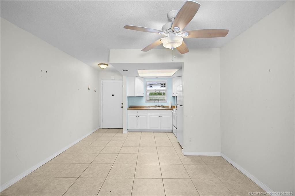 2929 Southeast Ocean Boulevard, Unit 1294 Stuart, FL 34996 - Photo 5 of 30 a view of an empty room with a kitchen